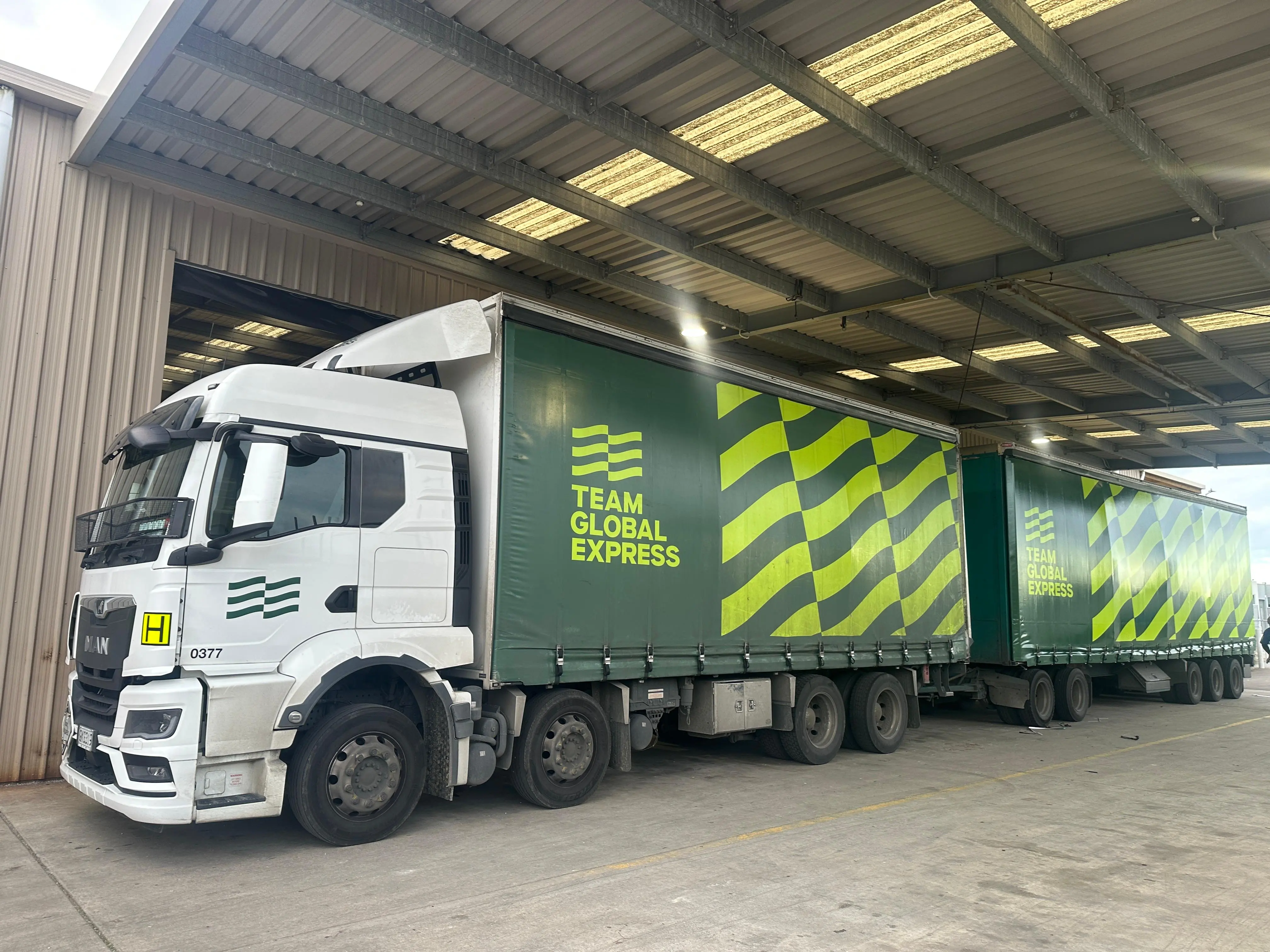 Curtainsider truck and trailer unit loaded at the depot